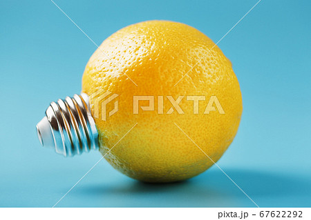 Lemon fruit as a light bulb on a blue background. Lemon fruit as a light bulb on a blue background. 67622292
