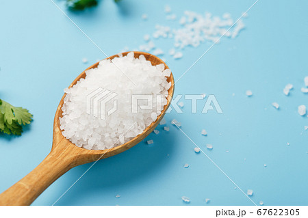 Sea salt in a wooden spoon on Large salt crystals Sea salt in a wooden spoon on Large salt crystals 67622305