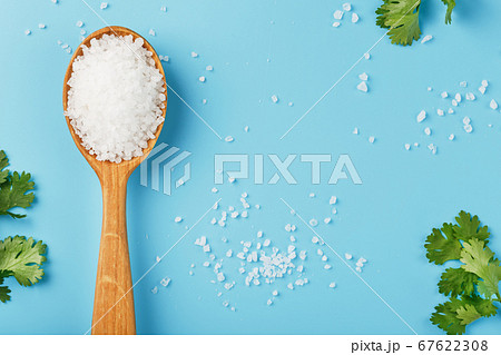 Sea salt in a wooden spoon on Large salt crystals Sea salt in a wooden spoon on Large salt crystals 67622308