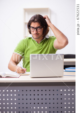 Young male student in the classroom Young male student in the classroom 67622531