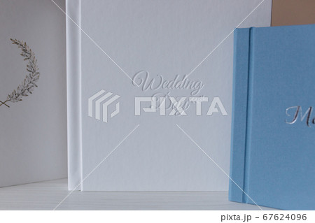 Photobook with different lettering on white wooden table Photobook with different lettering on white wooden table 67624096