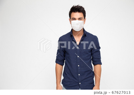Young caucasian man wearing face mask to protect from COVID-19  67627013