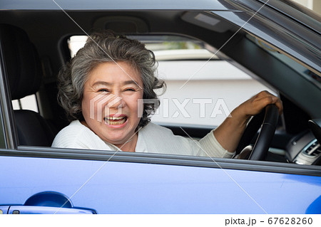 Asian senior woman driving a car and smile happy. Asian senior woman driving a car and smile happy. 67628260