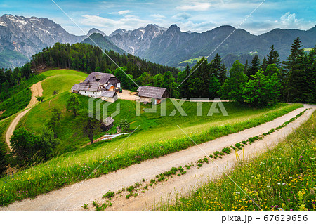 Rural farm in the forest glade with mountains, Slovenia Rural farm in the forest glade with mountains, Slovenia 67629656