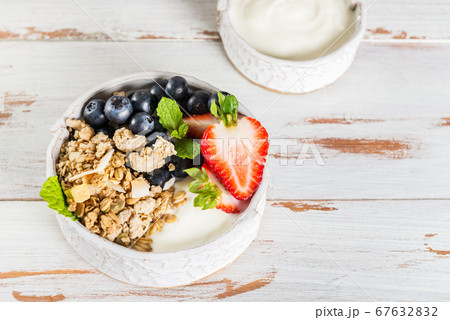 Bowl of natural yogurt with granola and fresh 67632832