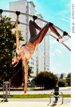 Strong and sexy sportive woman training outdoors, on the ground 67637107