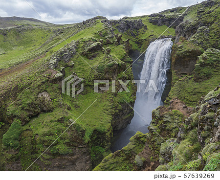 Beautifull waterfall on the Skoga River with rainbow and no people on famous Fimmvorduhals trail second part of Laugavegur trek. Summer landscape on a sunny day. Amazing in nature. August 2019, South 67639269