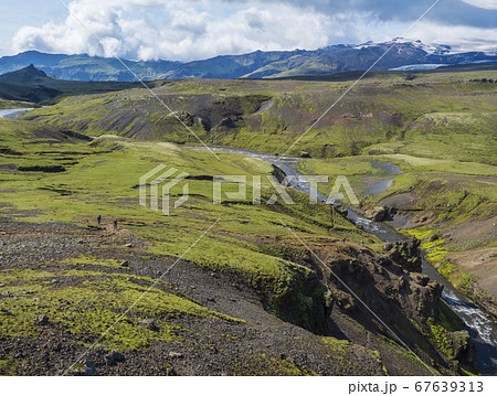 Beautiful lush green Landscape of Skoga river valley cascades near Skogafoss waterfall and Skogar end of Fimmvorduhals hiking trail. South Iceland, Summer blue sky 67639313