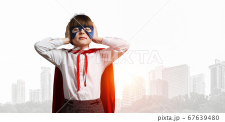 Kid girl superhero against cityscape background annoyed by city sounds 67639480