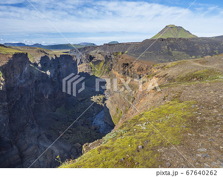 View on majestic Markarfljotsgljufur Canyon gorge and river with green hills and Hattafell mountain near Botnar camp at Fjallabak Nature Reserve in Highlands of Iceland, blue sky background 67640262