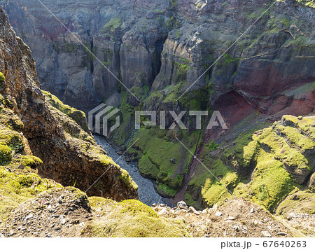 View on colorful stone walls of majestic Markarfljotsgljufur Canyon gorge and river at Fjallabak Nature Reserve in Highlands of Iceland View on colorful stone walls of majestic Markarfljotsgljufur Canyon gorge and river at Fjallabak Nature Reserve in Highlands of Iceland 67640263