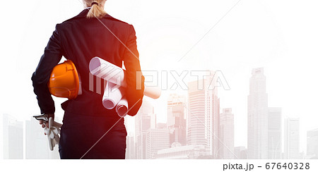 Woman architect with technical blueprints 67640328