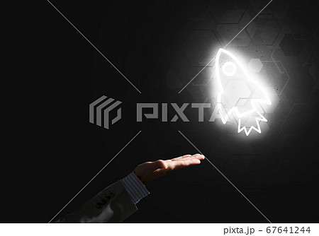 Man palm presenting Rocket web icon as technology concept Man palm presenting Rocket web icon as technology concept 67641244