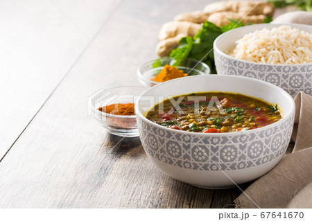Indian lentil soup dal (dhal) in a bowl on wooden table	 67641670
