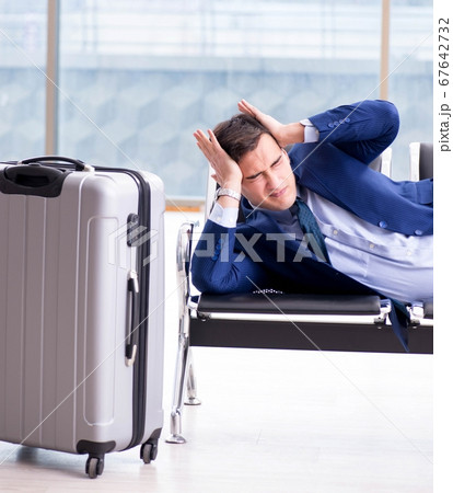 Businessman waiting at the airport for his plane in business cla 67642732