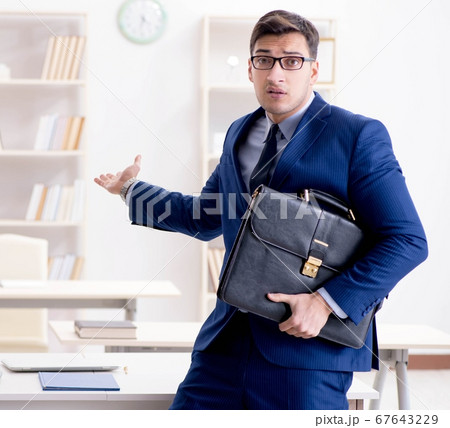 Young handsome businessman employee working in office at desk 67643229