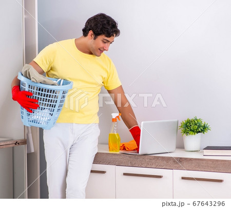 Young handsome man cleaning in the bedroom Young handsome man cleaning in the bedroom 67643296