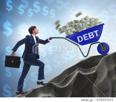 Businessman pushing wheelbarrow uphill in debt loan concept Businessman pushing wheelbarrow uphill in debt loan concept 67643343