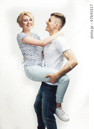 young pretty teenage couple, hipster guy with his girlfriend happy smiling and hugging isolated on white background, lifestyle people concept young pretty teenage couple, hipster guy with his girlfriend happy smiling and hugging isolated on white background, lifestyle people concept 67645817