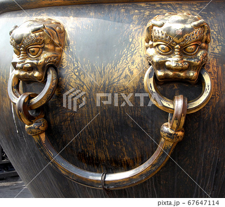 Forbidden City, Beijing, China. A bronze urn for fire control in the Forbidden City. The Forbidden City has traditional Chinese architecture. The Forbidden City is also the Palace Museum, Beijing. Forbidden City, Beijing, China. A bronze urn for fire control in the Forbidden City. The Forbidden City has traditional Chinese architecture. The Forbidden City is also the Palace Museum, Beijing. 67647114