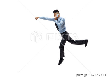 Man in office clothes practicing taekwondo on white background. Unusual look for businessman in motion, action. Sport, healthy lifestyle. Man in office clothes practicing taekwondo on white background. Unusual look for businessman in motion, action. Sport, healthy lifestyle. 67647471