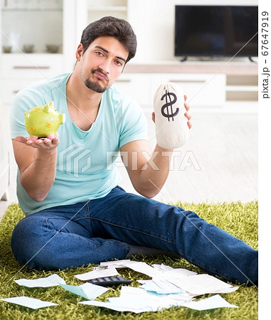 Young man struggling with personal finance and bills 67647919