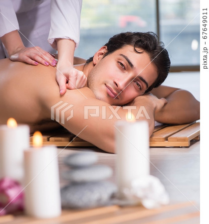 Young handsome man during spa procedure Young handsome man during spa procedure 67649011