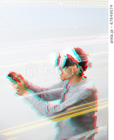 Man with virtual reality headset is playing game. Image with glitch effect. 67649074