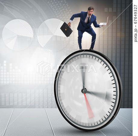 Businessman in time management concept 67649327