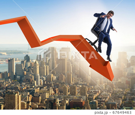Businessman sliding down on chair in economic crisis concept Businessman sliding down on chair in economic crisis concept 67649463