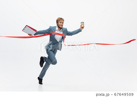 Man in office clothes running, jogging on white background. Unusual look for businessman in motion, action. Sport, healthy lifestyle. 67649509