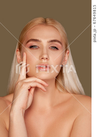 beauty portrait blonde woman touching face skin 67649815