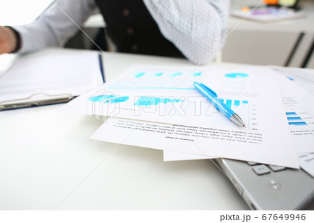 Focused photo on documents that lying on the laptop 67649946