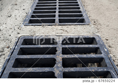 New rainwater grate on the road or sidewalk, New rainwater grate on the road or sidewalk, 67650224