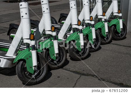 Rental Electric Scooters, e-scooter, Parked In Group On The Pavement Rental Electric Scooters, e-scooter, Parked In Group On The Pavement 67651200