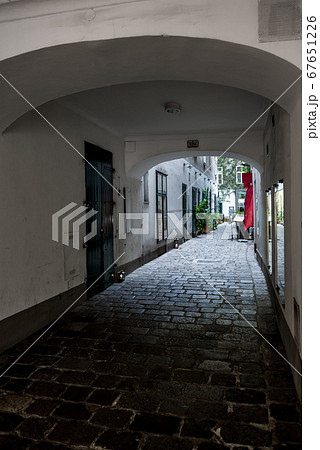 Entrance To The Backyard Of A Historic Building With A Picturesque Restaurant In The Inner City Of Vienna In Austria Entrance To The Backyard Of A Historic Building With A Picturesque Restaurant In The Inner City Of Vienna In Austria 67651226