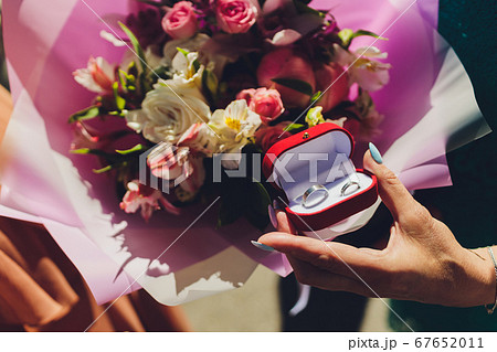 Close up of man holding wedding ring and gift box. Close up of man holding wedding ring and gift box. 67652011