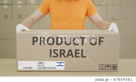 Warehouse worker and big box with PRODUCT OF ISRAEL printed text 67654361