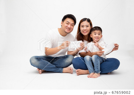 Asian family holding protective mask for prevent virus Asian family holding protective mask for prevent virus 67659002