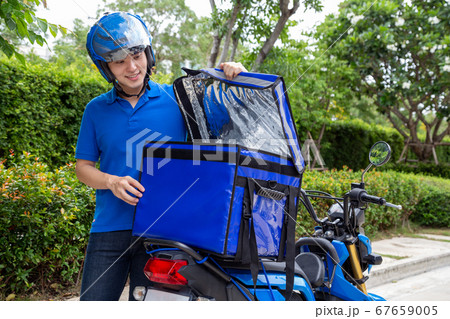 Young Asian man with delivery box. Young Asian man with delivery box. 67659005