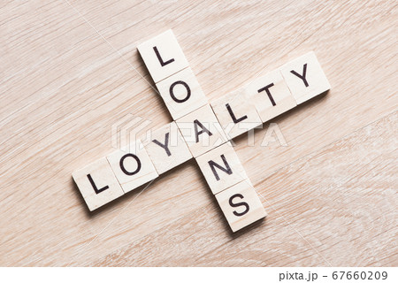 Conceptual business keywords on table with elements of game making crossword 67660209