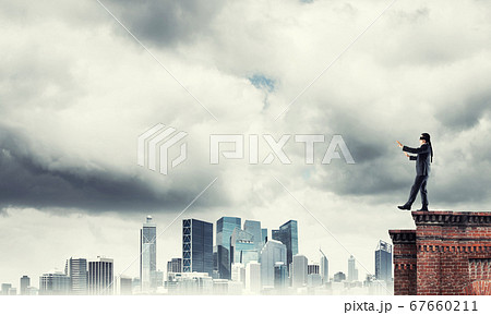 Danger and risk concept with businessman making step from edge 67660211
