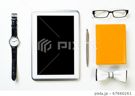 Gentleman kit of tablet watch glasses bow tie and notebook on wooden table 67660261