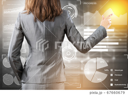 Businesswoman standing with back and pressing icon on media screen Businesswoman standing with back and pressing icon on media screen 67660679