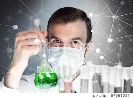 Portrait of concentrated male scientist working with reagents in laboratory 67661037