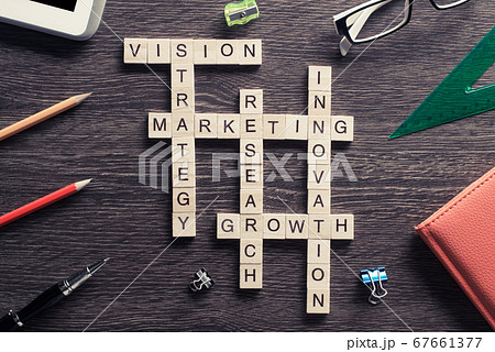 Business workplace with office stuff and wooden cubes making crossword 67661377