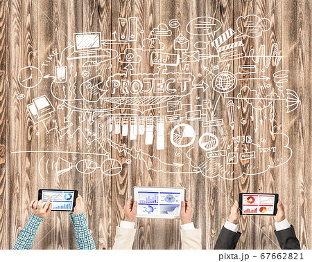 Top view of businesspeople sitting at table and using gadgets Top view of businesspeople sitting at table and using gadgets 67662821