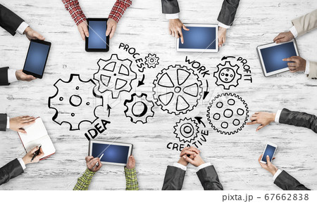 Top view of businesspeople sitting at table and using gadgets Top view of businesspeople sitting at table and using gadgets 67662838