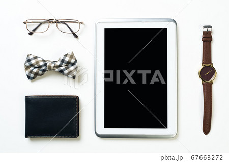 Gentleman kit of tablet watch glasses bow tie and notebook on wooden table 67663272