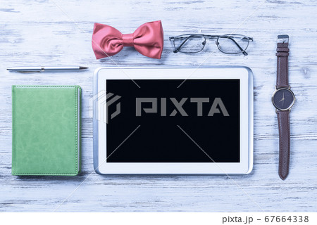 Gentleman kit of tablet watch glasses bow tie and notebook on wo Gentleman kit of tablet watch glasses bow tie and notebook on wo 67664338